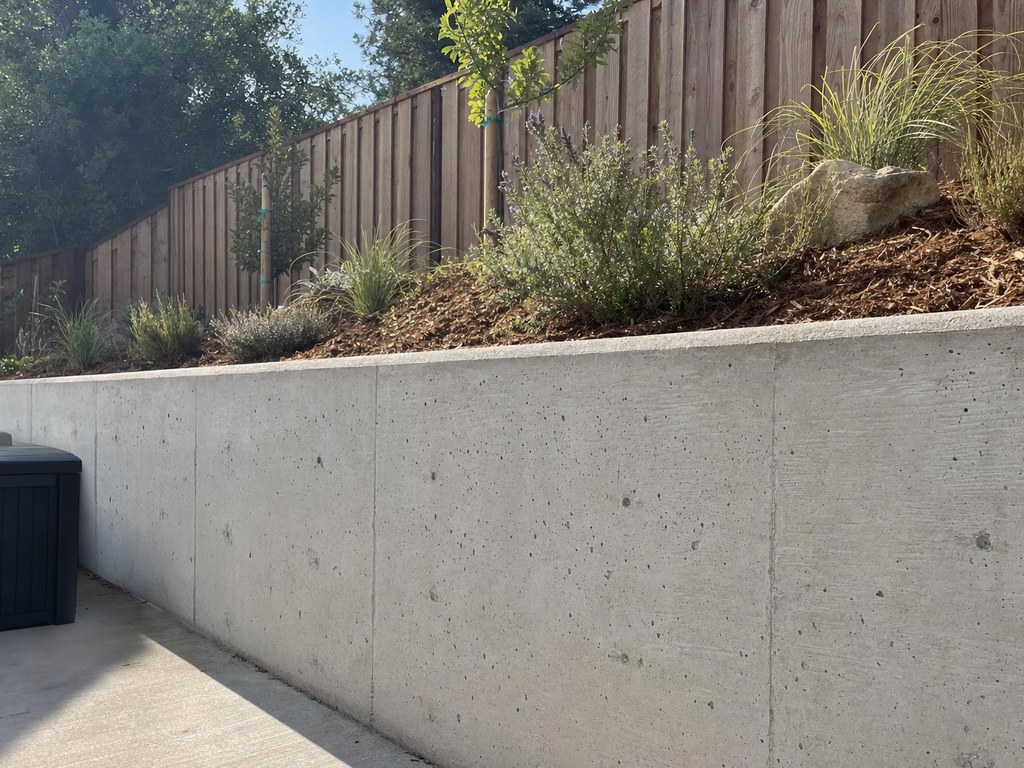 Poured concrete retaining wall in a Stockton backyard